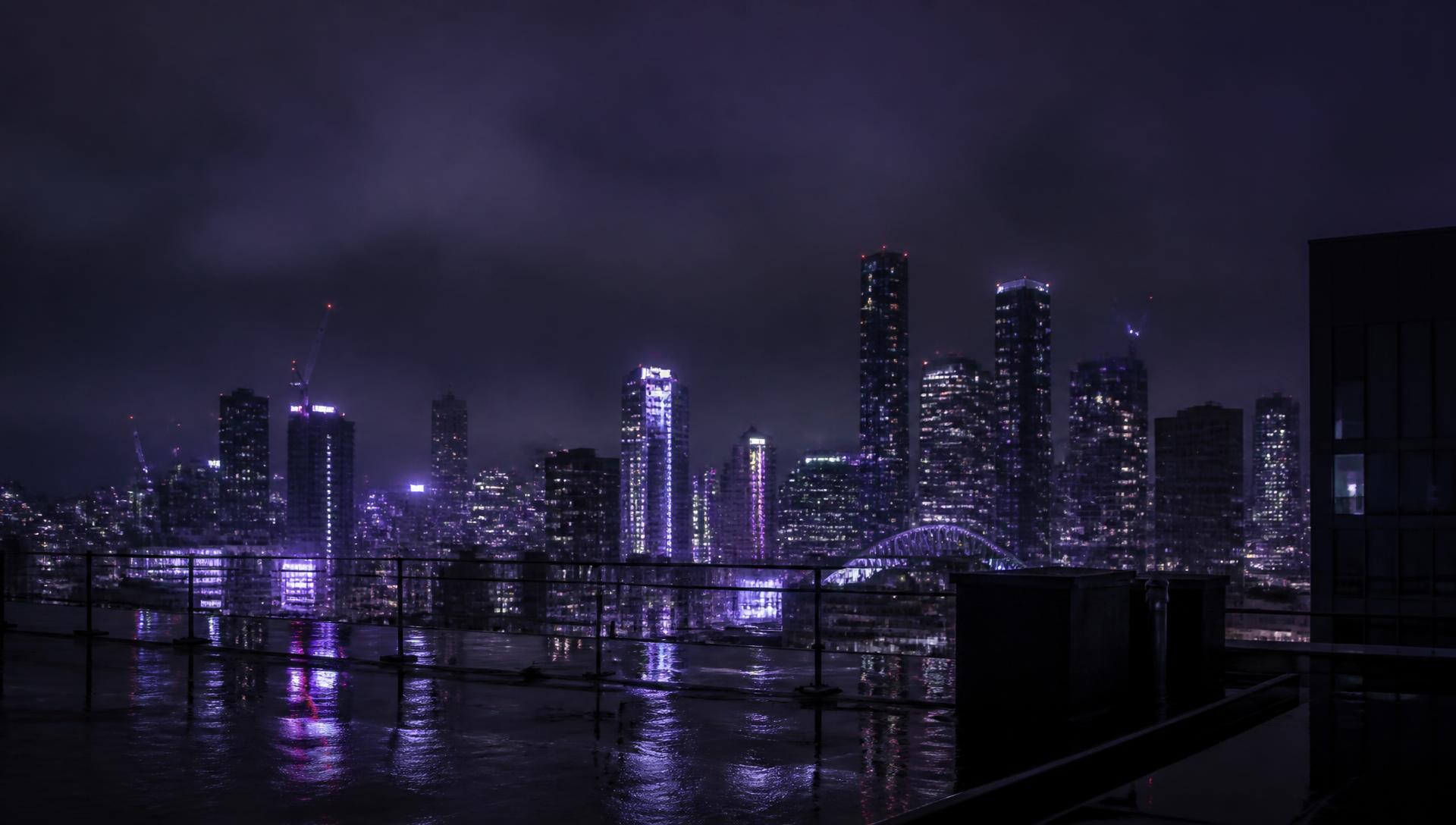 Manchester skyline at night in deep violet tones